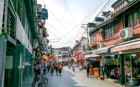 Old Shanghai lane with traditional shophouses and wires overhead