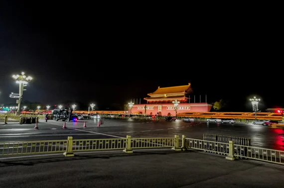 Tiananmen Gate illuminated at night with portrait of Mao Zedong