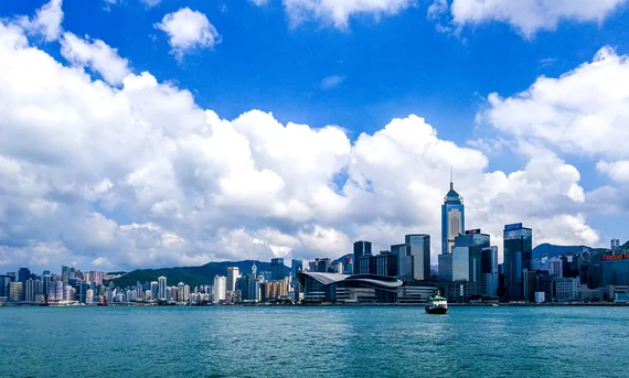 Hong Kong skyline across Victoria Harbour with dense skyscrapers