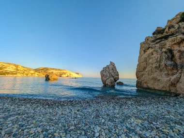 Another angle of Aphrodite's Rock with golden-lit cliffs