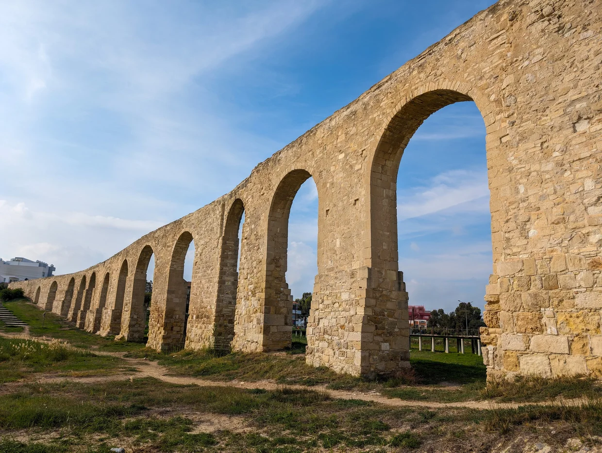 Kamares Aqueduct with large stone arches stretching into the distance