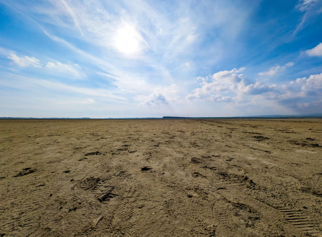 Vast flat dried salt lake stretching to the horizon