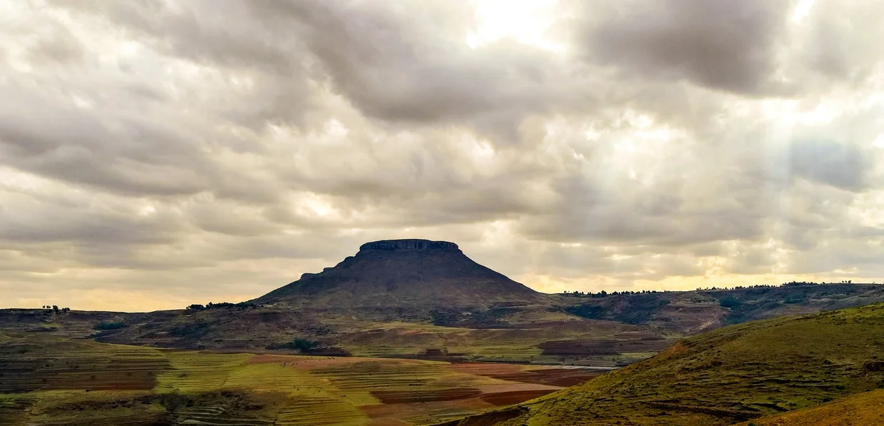 A flat-topped mountain under dramatic skies