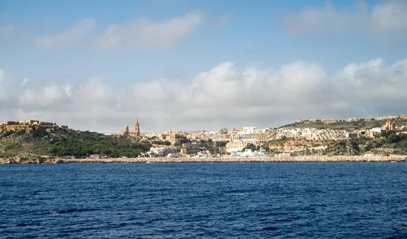 Mgarr harbour with church spires on the hillside
