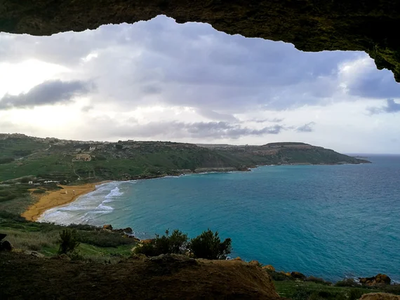View from Calypso's Cave overlooking Ramla Bay's red-golden sand