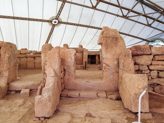 Tall standing stones forming an apse under the protective canopy