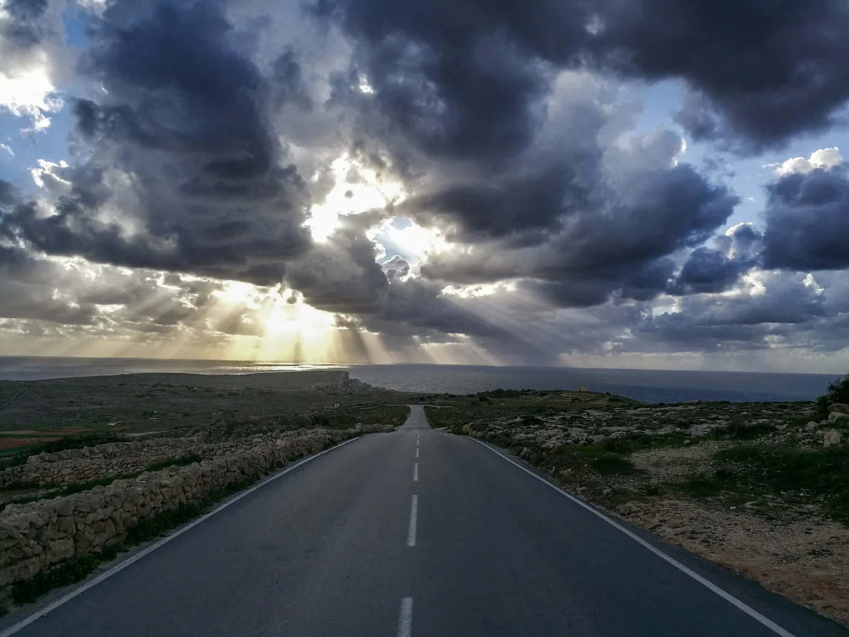 Straight road stretching across the flat Maltese countryside