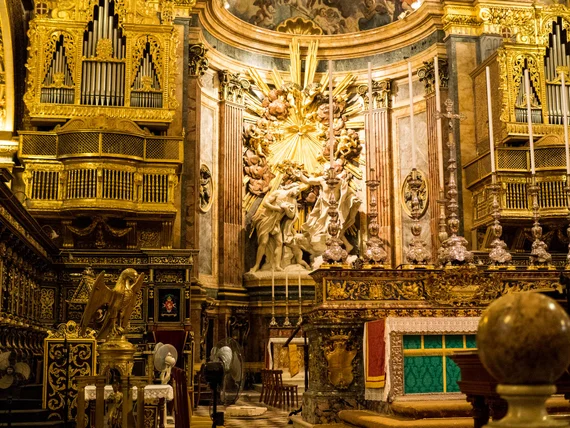 Sculptural altar group with marble figures and organ pipes