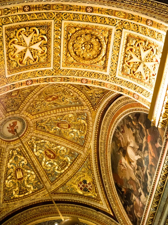 Vaulted ceiling with coffered gold panels and large ceiling painting