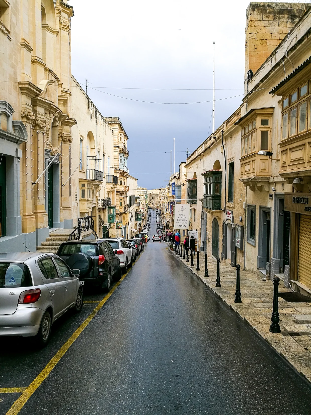 Town street on an overcast day with colorful enclosed balconies