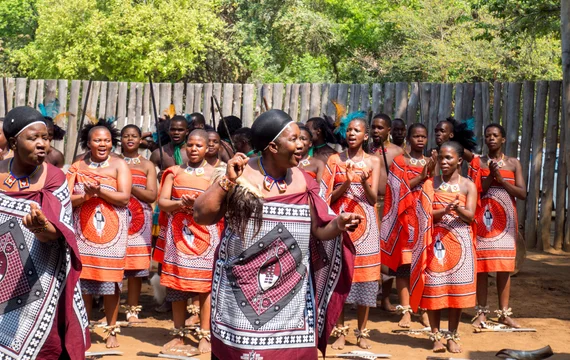 Traditional Swazi dancers in colorful dress performing at Mantenga Cultural Village