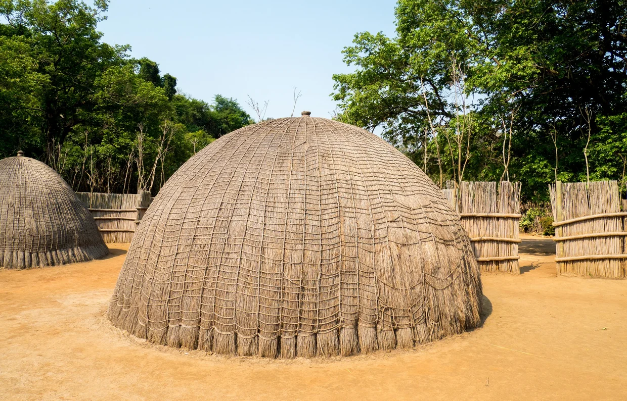 Traditional beehive hut made of woven grass at a Swazi cultural village