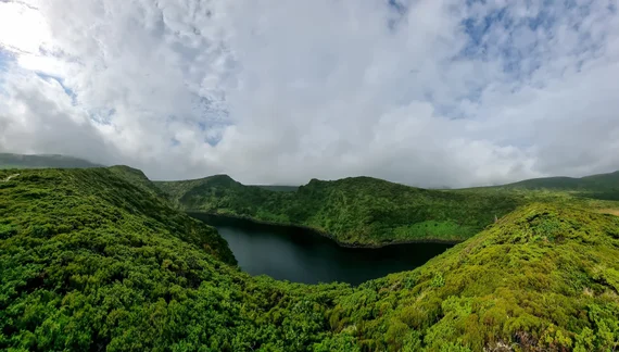 Crater lake panorama surrounded by green