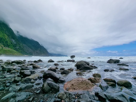 Boulders in the surf, moody clouds over the north coast