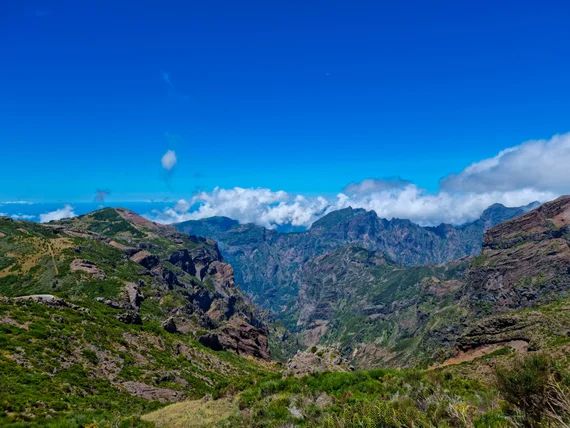 Wide mountain panorama, deep valleys, blue sky