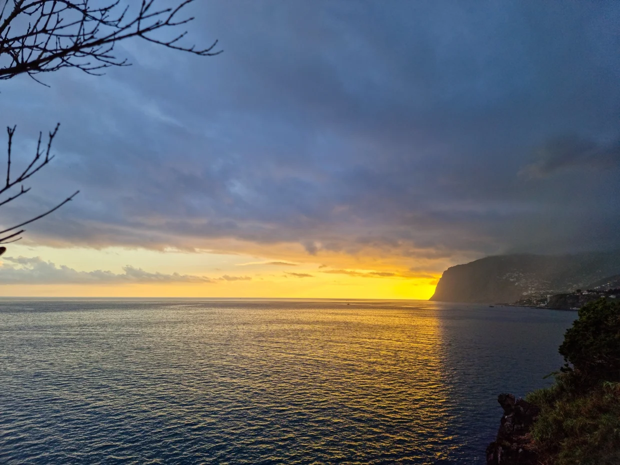 Sunset over the Atlantic from the coast near Funchal, golden light on the water