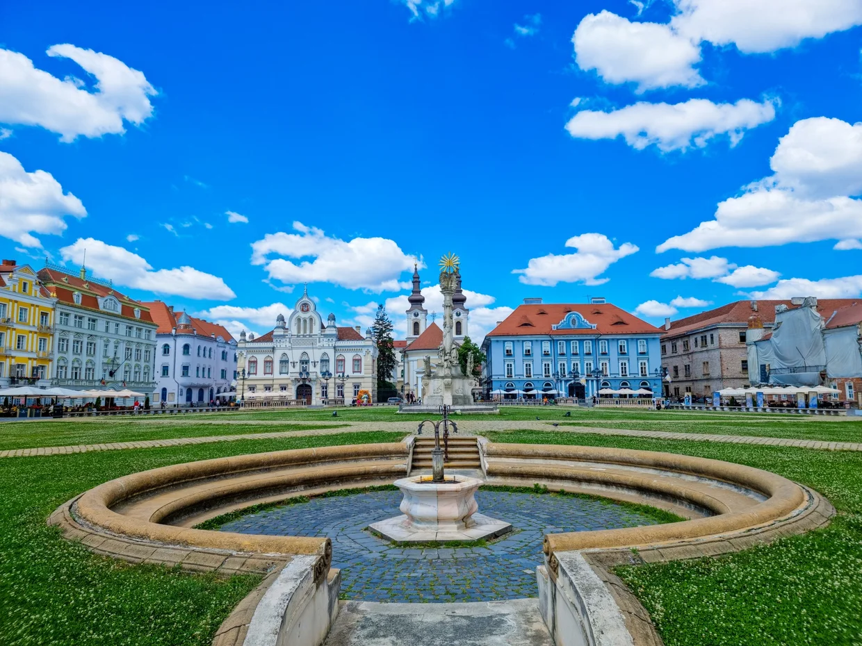 Union Square in Timișoara under a bright pastel sky