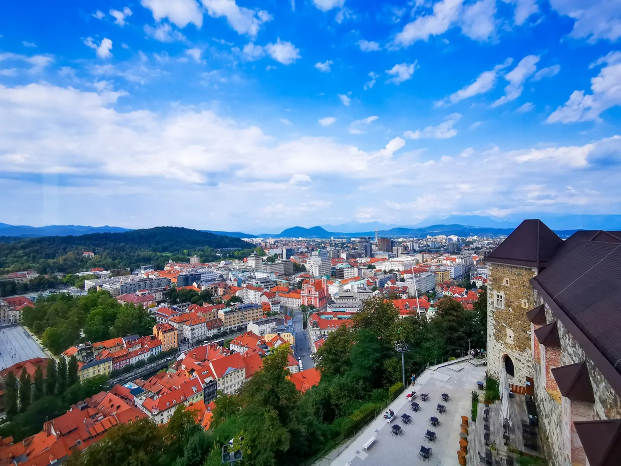 View of Ljubljana from the castle ramparts, red roofs rolling out below and hills beyond