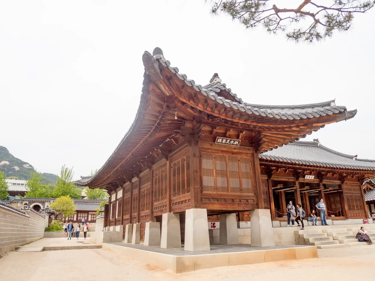 Traditional wooden hanok building with sweeping curved roof