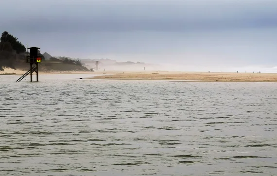 Misty beach with lifeguard tower