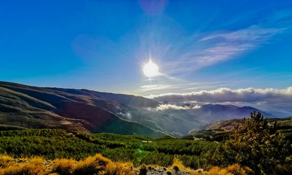 Sun breaking through over the peaks