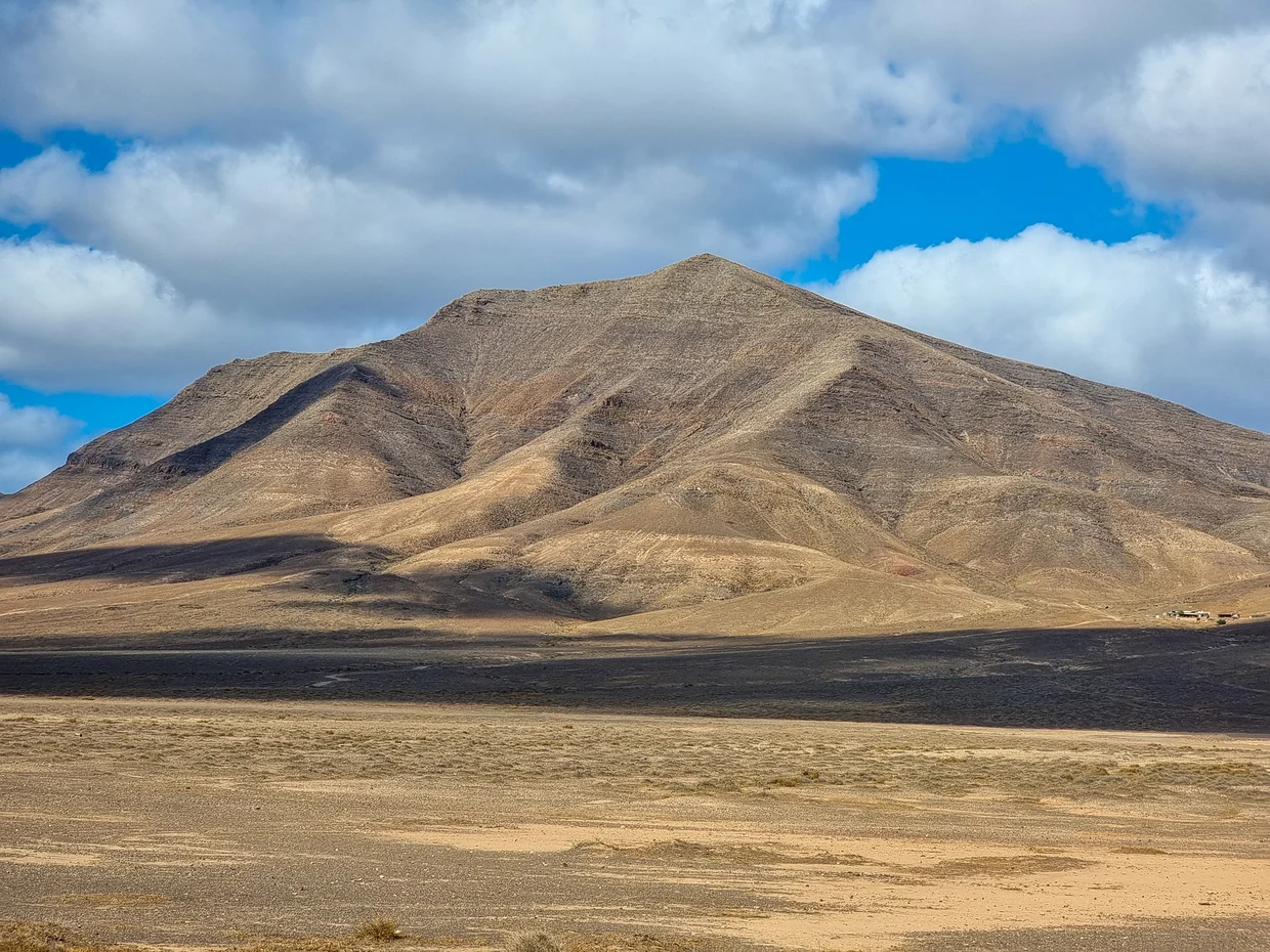 Dramatic layered mountain in a vast arid plain
