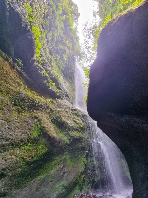 Waterfall cascading down narrow rocky gorge