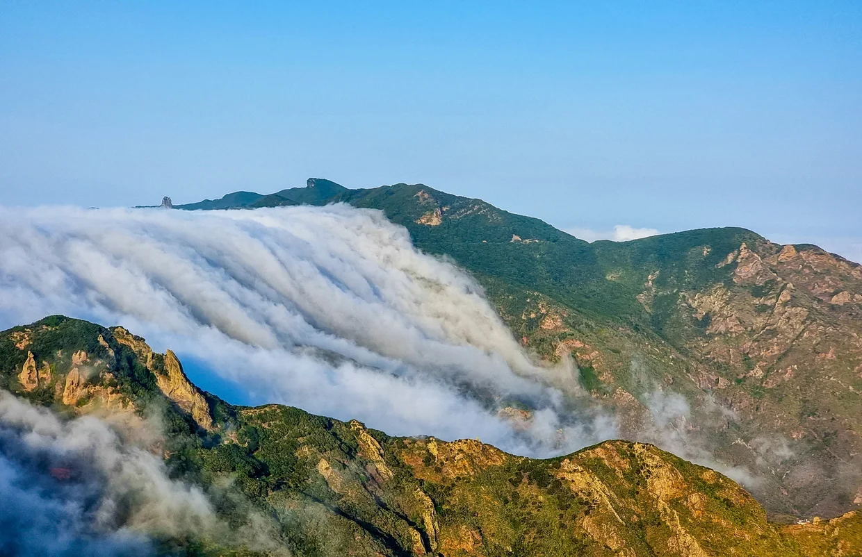 Cloud waterfall pouring over the mountains of La Gomera