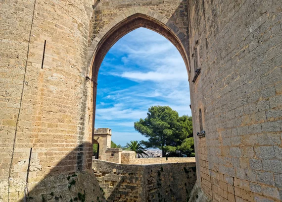 Gothic pointed arch framing a view through the castle walls