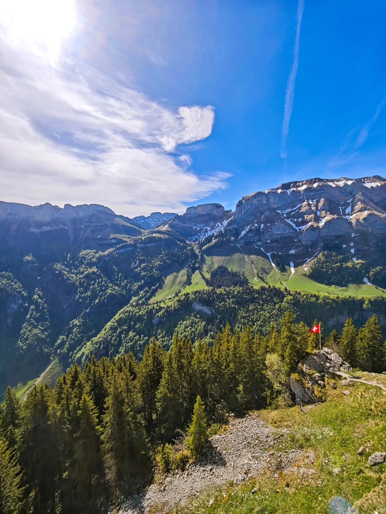 The Swiss flag perched on a rocky outcrop just below Ebenalp's summit