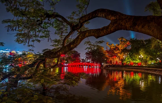 The Huc Bridge glowing red over Hoan Kiem Lake