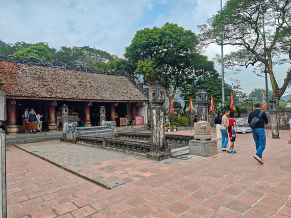 Visitors in the courtyard of a historic Hoa Lu temple