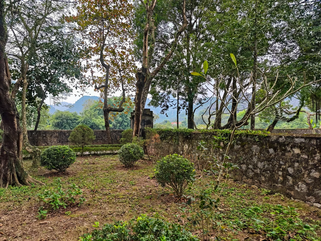 Quiet tree-lined garden area inside the Hoa Lu complex